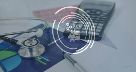 Image of business icons over stethoscope and calculator