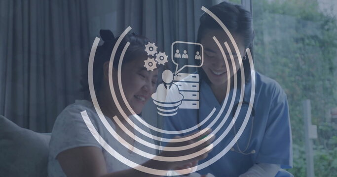 Image of business icons over asian female doctor and patient