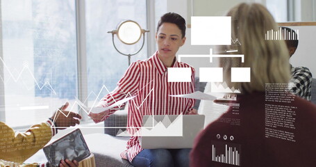 Image of diagrams and data processing over diverse colleagues discussing work in office