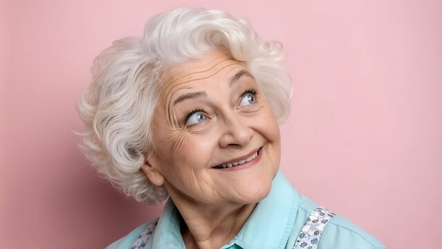 Joyful Senior Woman with Gentle Smile Against Pink Background