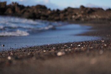 Close up Black lava rock sand beach in Maui Hawaii