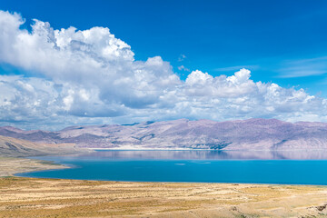The sacred Manasarovar lake with blue transparent water in the mountains of Tibet