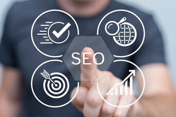 Web developer working on virtual touch screen presses text: SEO. Search Engine Optimization. SEO...