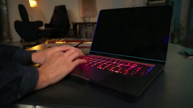 "A sleek laptop with an ultra-thin bezel and a glowing backlit keyboard, placed in a modern workspace."
