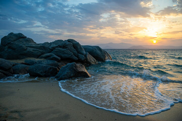 Sunset over Paros viewed from Plaka beach on Naxos in the Greek islands.