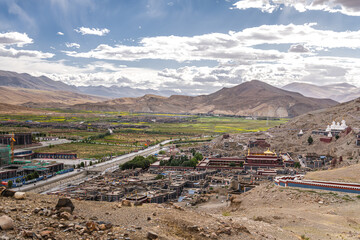 White stupa with golden top and part of the the buddhist Sakya Monastery, Tibet