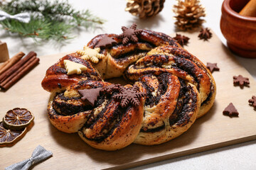 Tasty Christmas pastry wreath with cookies on white background