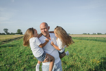 Fototapeta premium Dad has two children in his arms.Happy kids dad
