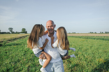 Dad has two children in his arms.Happy kids dad
