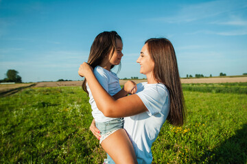 The family spends leisure time in the fresh air. Sisters are having fun.