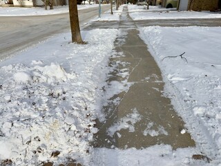 winter sidewalk cleared of snow