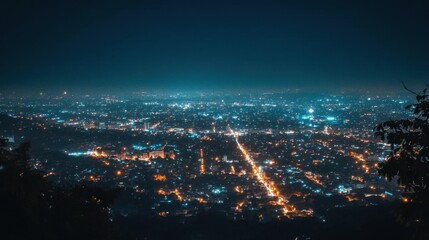 Obraz premium A panoramic night view of a city illuminated with lights.