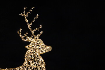 Lights representing the silhouette of a deer with a dark background. Christmas time with a beautiful lighting representing animal. December events and peaceful image for calendar.	