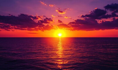 Naklejka premium A vibrant sunset over the ocean, casting colorful reflections on the water.