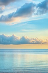 Obraz premium Serene seascape at dusk with soft clouds and calm waters.