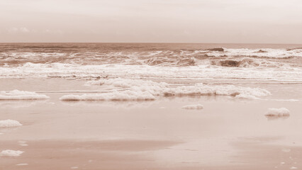 Tranquil Coastal Scene White Sea Foam and Waves on Crystal Clear Beach. Colour of the year Mocha Mousse.