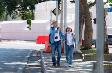 An elderly couple walks around the street in the old city of Bangkok, Thailand.