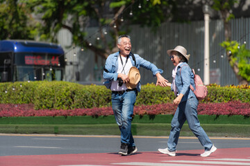 Fototapeta premium An elderly couple walks around the street in the old city of Bangkok, Thailand.