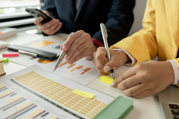 Businessman brainstorming to find strategies to increase revenue for the company. Two coworkers are discussing about the work in progress. Two employees are working as a team. Business meeting.