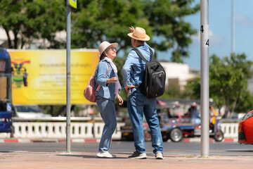 An elderly couple walks around the street in the old city of Bangkok, Thailand.