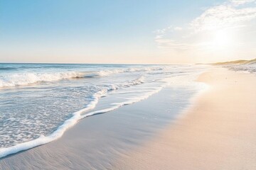 Serene beach scene with gentle waves and soft sand under a clear sky.