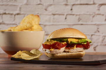 sandwich with chicken ,vegetables, and sauces