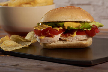 sandwich with chicken ,vegetables, and sauces