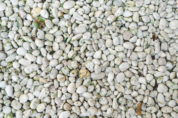 Pebble stone texture on the ground. The pebbles closely stone texture features.