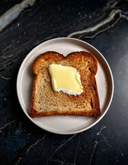 Buttered toast on a plate. Simple breakfast.