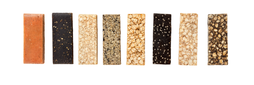 Variety of Energy Bars Arranged Neatly on a White Background Showcasing Diverse Flavors and Ingredients for Healthy Snacking Options - Powered by Adobe