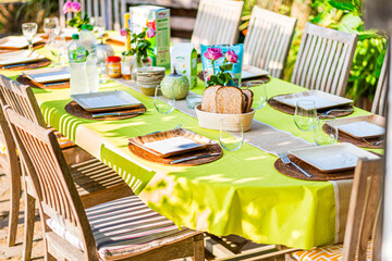 Outdoor Table Set For a Vibrant Brunch Gathering With Colorful Tablecloth and Fresh Flowers