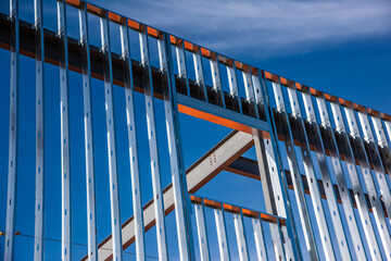 Metal studs along exterior wall of steel framed office building under construction.