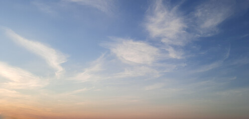 Obraz premium beautiful sky with pink clouds and sun. nature and beauty pink clouds on blue sky