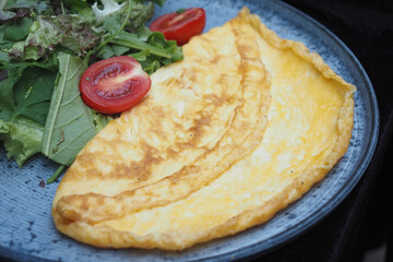 A Delicious Golden Omelette Beautifully Served on a Plate, Perfectly Ready to Be Enjoyed