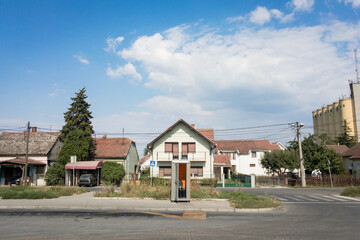 Suburban scene in Batajnica, Serbia, featuring red-tiled roof houses, a portable toilet, ivy-clad structures. Batajnica is an urban settlement part of Belgrade.