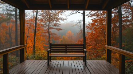 A cozy cabin porch with a wooden bench, overlooking an autumn forest in the foggy morning