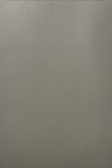 a close up of a gray leather surface with a small square