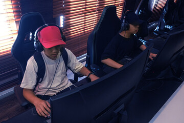 Gamers Playing Video Games On Their Computers At Cybercafe