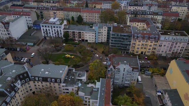 Yellow ADAC helicopter. fire in a residential building in berlin, germany, demonstrating the importance of emergency services. Perfect aerial view flight drone shot footage from above