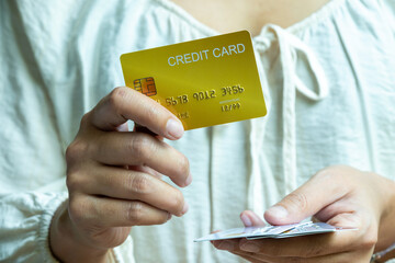 Woman holding credit cards and he is choosing a credit card to pay and spend Payment for goods via credit card. Finance and banking concept	