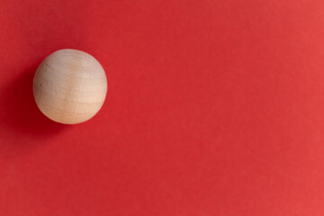 赤背景に木でできたボール