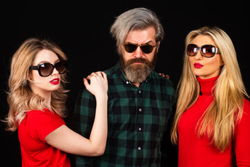 Obraz premium Group of fashion models posing in studio. Group of tree People. Friends face. Three young people portrait. Great team. Group of three cheerful young people in casual wear looking at camera.