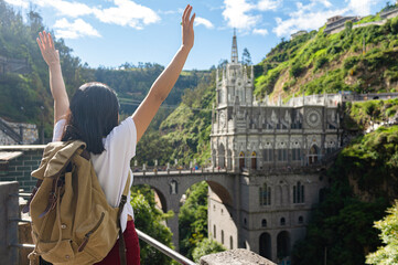 Fototapeta premium Female tourist at the church of Las Lajas, in southern Colombia