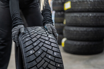Mechanic keeps new studded car tires in garage. 