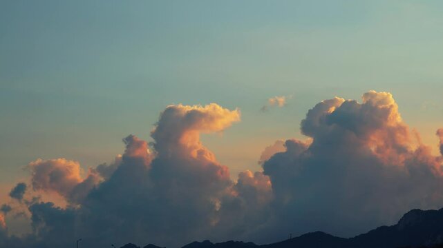 Time lapse of clouds colored by the sunset