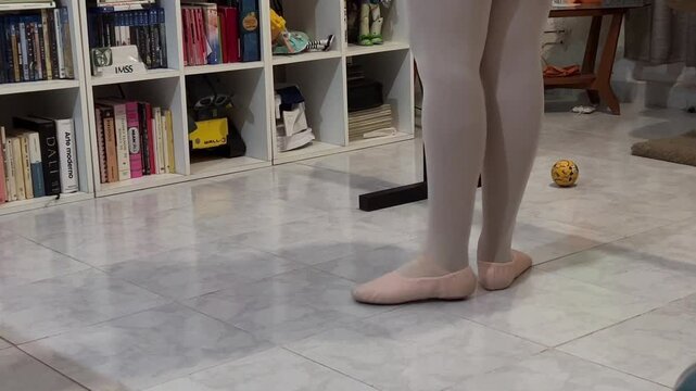 Moving legs of a classical dance dancer with her pointe shoes, ballet or sylph shoes.