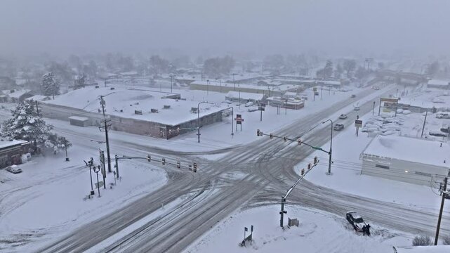 Aerial shot over light on State Street in Midvale Utah with intense snow storm