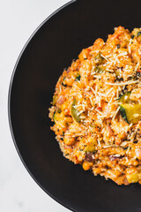 risoni with Mediterranean vegetables and creamy tomato sauce topped with parmesan cheese and pepper