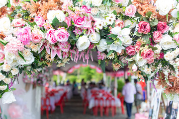 Colorful roses in the background create a party atmosphere.