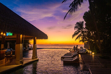 Sunset views from overwater pool villa in Maldives